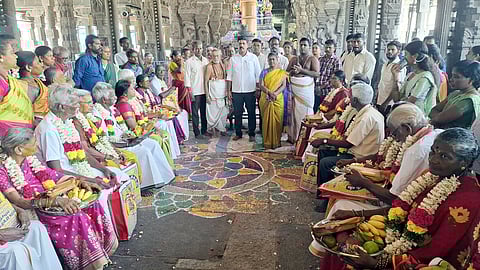 முதிய தம்பதிக்கு மரியாதை செய்த அறநிலையத்துறை இணை ஆணையா் சி.குமாரதுரை, கோயில் செயல் அலுவலா் ப.முத்துலட்சுமி