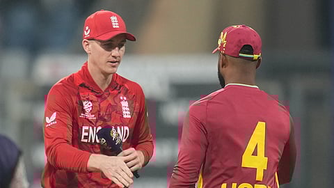England's captain Harry Brook, left, and West Indies' captain Shai Hope shake hands after the coin toss of the T20 World Cup cricket match between England and West Indies in Mumbai, India, Wednesday, Feb. 11, 2026. (AP Photo/Rafiq Maqbool)