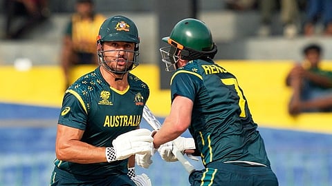 Australia's Marcus Stoinis, left, and batting partner Matthew Renshaw run between the wickets during the T20 World Cup cricket match between Australia and Ireland in Colombo, Sri Lanka, Wednesday, Feb. 11, 2026. (AP Photo/Eranga Jayawardena)