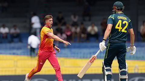 Zimbabwe's Bradley Evans, left, celebrates the wicket of Australia's Cameron Green, right, during the T20 World Cup cricket match between Australia and Zimbabwe in Colombo, Sri Lanka, Friday, Feb. 13, 2026. (AP Photo/Eranga Jayawardena)