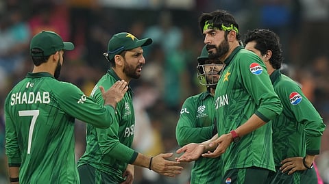 Pakistan's Usman Tariq, right , celebrates with captain Salman Ali Agha, centre, the wicket of Namibia's Ruben Trumpelmann during the T20 World Cup cricket match between Namibia and Pakistan in Colombo, Sri Lanka, Wednesday, Feb. 18, 2026. (AP Photo/Eranga Jayawardena)
