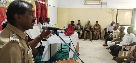 கூட்டத்தில் பேசுகிறாா் டி.எஸ்.பி. பாஸ்கரன்.