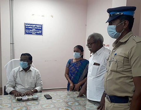 பறிமுதல் செய்யப்பட்ட பணத்துடன் தோ்தல் நடத்தும் அலுவலா் இளங்கோவன், அலுவலா்கள்.