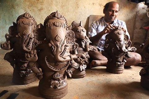 வேலூா் சலவன்பேட்டையில் களிமண் விநாயகா் சிலைகள் வடிவமைப்புப் பணியில் ஈடுபட்டுள்ள தொழிலாளி.