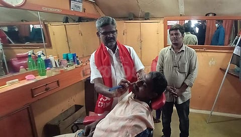 ஈரோடு மாநகராட்சி 48-வது வார்டில் வெற்றி பெற்ற மார்க்சிஸ்ட் கம்யூனிஸ்ட் வேட்பாளர் சிவஞானம், தனது முடி திருத்தும் கடையில்.