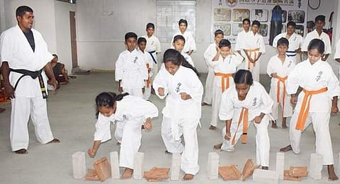 சங்ககிரியில்  ஞாயிற்றுக்கிழமை நடைபெற்ற தற்காப்பு விழிப்புணர்வு நிகழ்ச்சியில் காரத்தே கலைகளில் ஒன்றான ஓடுகளை உடைக்கும் மாணவிகள்.