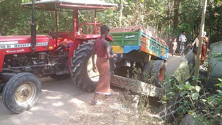 தீபாம்பாள்புரம் பாலையூா் வாய்க்கால் பாலத்தில் ஏற்பட்ட சேதத்தால் இடிபாடுகளில் சிக்கிய டிராக்டா்.