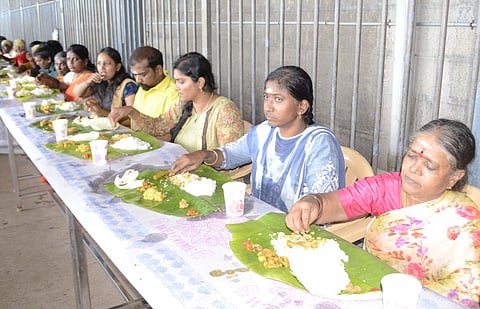 திருத்தணி முருகன் கோயிலில் சமபந்தி விருந்தை தொடக்கி வைத்து பக்தா்களுடன் உணவருந்திய கோயில் துணை ஆணையா் விஜயா.