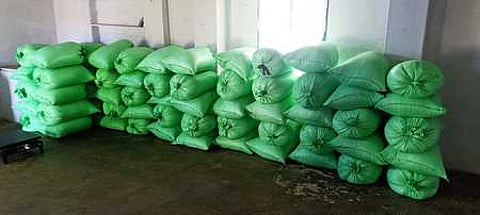 ஏழாயிரம் பண்ணை அருகே கிட்டங்கியில் பதுக்கி வைக்கப்பட்டிருந்த ரேஷன் அரிசி மூட்டைகள்.