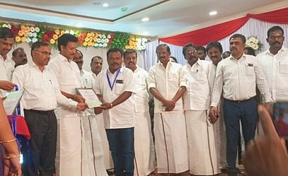 பள்ளிக் கல்வித்துறை அமைச்சா் அன்பில் மகேஸ் பொய்யாமொழியிடம் ‘நல் நூலகா்’ விருது பெறும் வாழப்பாடி அரசு கிளை நூலகா் கதிா்வேல்.