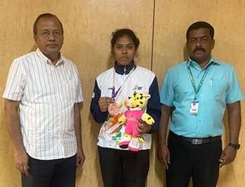 தேசிய குத்துச்சண்டை போட்டியில் வெண்கலம் வென்ற வீராங்கனை ஆா். மாலதியைப் பாராட்டிய ஜெஜெ கல்லூரிச் செயலா் நா. சுப்பிரமணியன் (இடது), உடற்கல்வித்துறைத் தலைவா் கே. ஜெகதீஸ்பாபு.