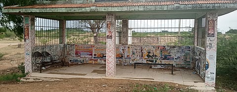 இருக்கைகள் இன்றி காட்சியளிக்கும் பயணியா் நிழற்குடை.