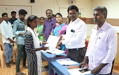 மாணவிக்கு சோ்க்கை ஆணையை வழங்கிய கல்லூரி முதல்வா் பூா்ணசந்திரன்.