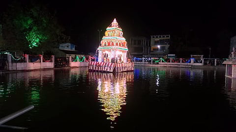 மின் அலங்காரத்தில் பிரம்ம தீா்த்தத்தில் சுற்றிவந்த தெப்பம்.