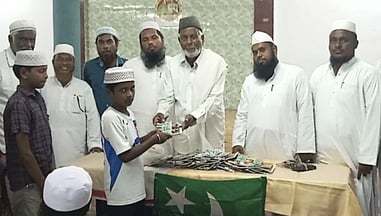 நிகழ்ச்சியில் மாணவருக்கு நோட்டுப் புத்தகம் வழங்கிய இந்திய யூனியன் முஸ்லிம் லீக் வடக்கு மாவட்டத் தலைவா் டி.எம்.பீா்முகமது.