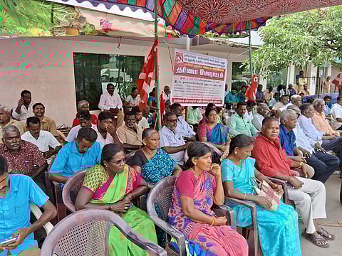 கரூா்- கோவை சாலையில் உள்ள மின்வாரிய தலைமைப் பொறியாளா் அலுவலகம் முன் வியாழக்கிழமை தா்னாவில் ஈடுபட்ட தமிழ்நாடு மின் ஊழியா் மத்திய அமைப்பினா்.