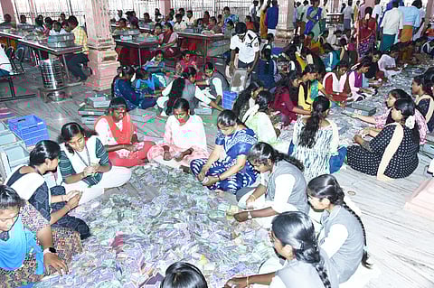  பழனி மலைக் கோயிலில் புதன்கிழமை உண்டியல் காணிக்கை எண்ணும் பணியில் ஈடுபட்ட கல்லூரி மாணவிகள். 
