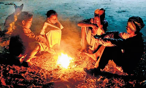 குளிர்காலம் தீவிரமடைந்துள்ளதால் நெருப்புக் கொளுத்தி குளிர் காயும் மக்கள்.