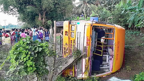  காட்டுமன்னாா்கோவில் அருகே சாலையோரம் கவிழ்ந்து கிடக்கும் தனியாா் பள்ளி வேன்.