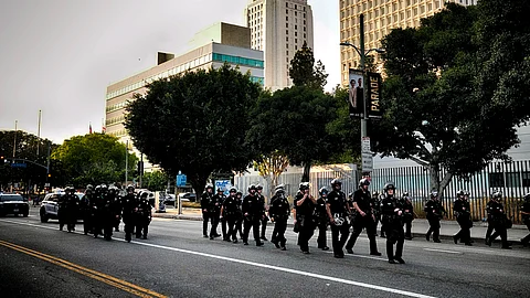 A Los Angeles police officers clear a street near Los Angeles City Hall in downtown