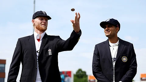 Ben Stokes flips a coin. Indian captain Shubman Gill is nearby.