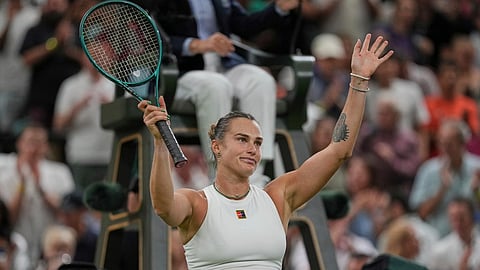 Aryna Sabalenka of Belarus celebrates after beating Emma Raducanu of Britain to win a third round women's singles match at the Wimbledon 