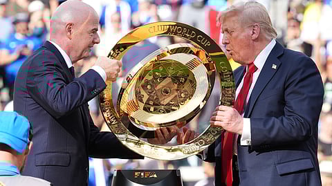 President Donald Trump, right, and FIFA President Gianni Infantino carry the championship trophy at the conclusion of the Club World Cup final soccer match at MetLife Stadium 