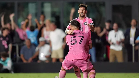 Inter Miami defender Marcelo Weigandt (57) lifts teammate forward Lionel Messi