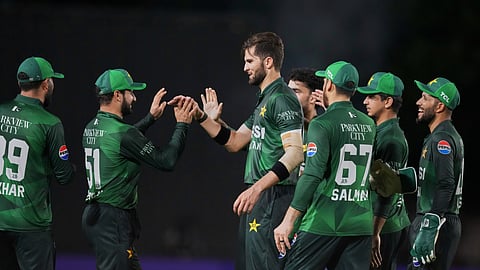 Pakistan's Shaheen Shah Afridi, center, celebrates with teammates after taking the wicket of West Indies'