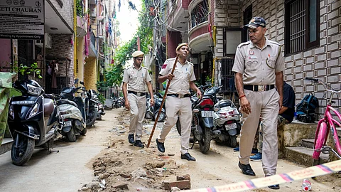 Police personnel investigate near the spot after Asif Qureshi, cousin of actor Huma Qureshi, was stabbed to death following a dispute over parking, at Bhogal in New Delhi