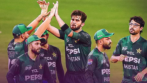 Pakistan players celebrate after taking a wicket.