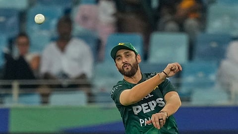 Pakistan's captain Salman Agha fields a ball during the Asia Cup cricket match between Pakistan and United Arab Emirates.