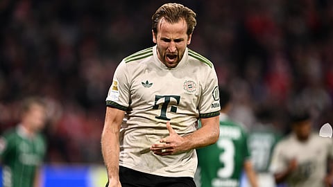Bayern's Harry Kane celebrates scoring from the penalty spot during the Bundesliga soccer match, Germany. 
