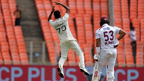 India's Mohammed Siraj, left, celebrates the dismissal of West Indies' Brandon King on the first day of the first Test cricket match in Ahmedabad,
