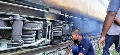  ரயில் பெட்டியின் கீழே தீயை அணைத்து கோளாறை சரி செய்த ஊழியா்.