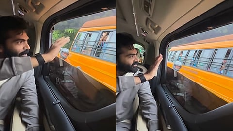 பள்ளிக் குழந்தைகளை நோக்கி கையசைக்கும் சிலம்பரசன் 