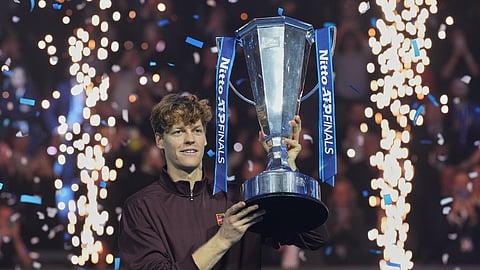 Italy's Jannik Sinner holds the trophy after winning the final tennis match of the ATP World Tour Finals against Spain's Carlos Alcaraz in Turin, Italy
