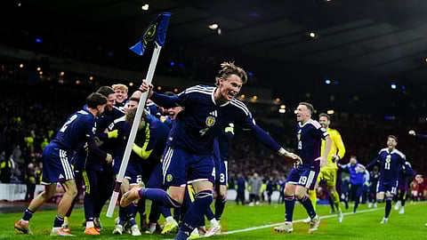 Scotland's Scott McTominay celebrates with teammates after Kenny McLean scored their fourth goal in the 2026 World Cup European Qualifying match.