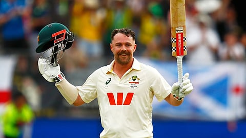 Travis Head celebrates after scoring a century