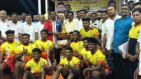 போட்டியில் முதல் பரிசு வென்ற கரூா் குட்டப்பட்டி அணிக்கு கோப்பை வழங்கிய கபடி விளையாட்டில் அா்ஜூனா விருதுபெற்ற கபடி வீரா் மணத்தி கணேசன். 

