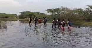 இடுப்பளவு தண்ணீரைக் கடந்து
மாணவா்கள் பள்ளி செல்லும் அவலம்