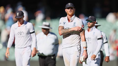 England's captain Ben Stokes, along with his team members, walks back to the pavilion at the end of day one of the third Ashes cricket Test between England and Australia at the Adelaide Oval in Adelaide, Australia,
