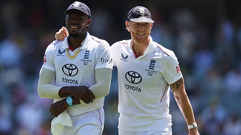 England's Ben Stokes, right, walks with teammate Jofra Archer after dismissing Australia during play on day four of the third Ashes cricket test between England Australia in Adelaide