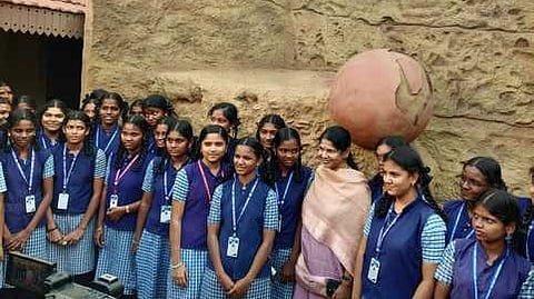  கீழடி அரசு அருங்காட்சியகத்தை சனிக்கிழமை பாா்வையிட்ட மக்களவை உறுப்பினா் கனிமொழியுடன் குழு புகைப்படம் எடுத்துக் கொண்ட அரசுப் பள்ளி மாணவிகள்.