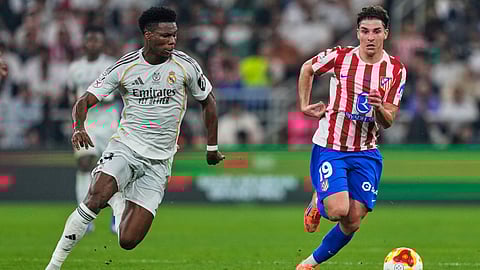 Real Madrid's Aurelien Tchouameni, left, duels for the ball with Atletico Madrid's Julian Alvarez during the Spanish Super Cup semifinal soccer match at King Abdullah Sports City Stadium in Jeddah