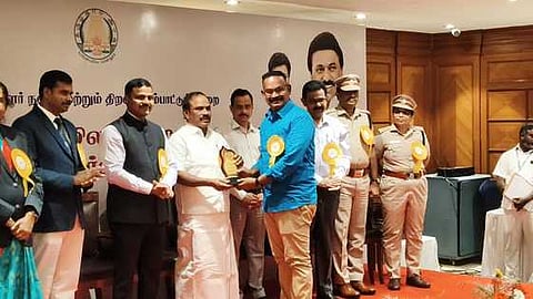 சமூக  சேவைக்காக  அமைச்சா்  சி.வி.கணேசனிடம் இருந்து விருதை பெற்றுக்கொண்ட ரீடு நிறுவன  இயக்குநா்  இரா.கருப்புசாமி.