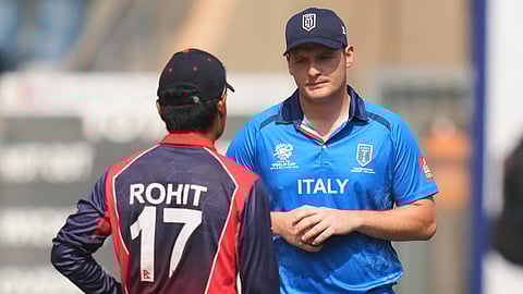 Italy's captain Wayne Madsen, right, Nepal's captain Rohit Paudel have a chat before the coin toss of the T20 World Cup cricket match between Italy and Nepal in Mumbai.