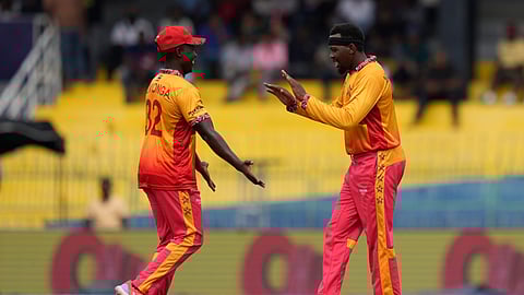 Zimbabwe's Wellington Masakadza, right, celebrates the wicket of Australia's Marcus Stoinis during the T20 World Cup cricket match between Australia and Zimbabwe in Colombo, Sri Lanka, Friday, Feb. 13, 2026. (AP Photo/Eranga Jayawardena)
