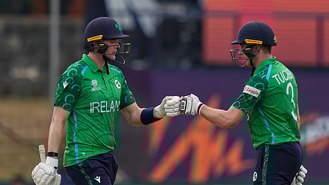 Ireland's Gareth Delany, left, Lorcan Tucker, right, encourage each other as they bat during the T20 World Cup cricket match between Ireland and Oman in Colombo, Sri Lanka, Saturday, Feb. 14, 2026. (AP Photo/Eranga Jayawardena)