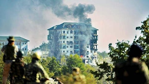 பாம்போரில் பயங்கரவாதிகளுடன் சண்டை நடைபெறும் அரசுக் கட்டடத்தில் பற்றிய தீயிலிருந்து வெளியேறும் புகை.